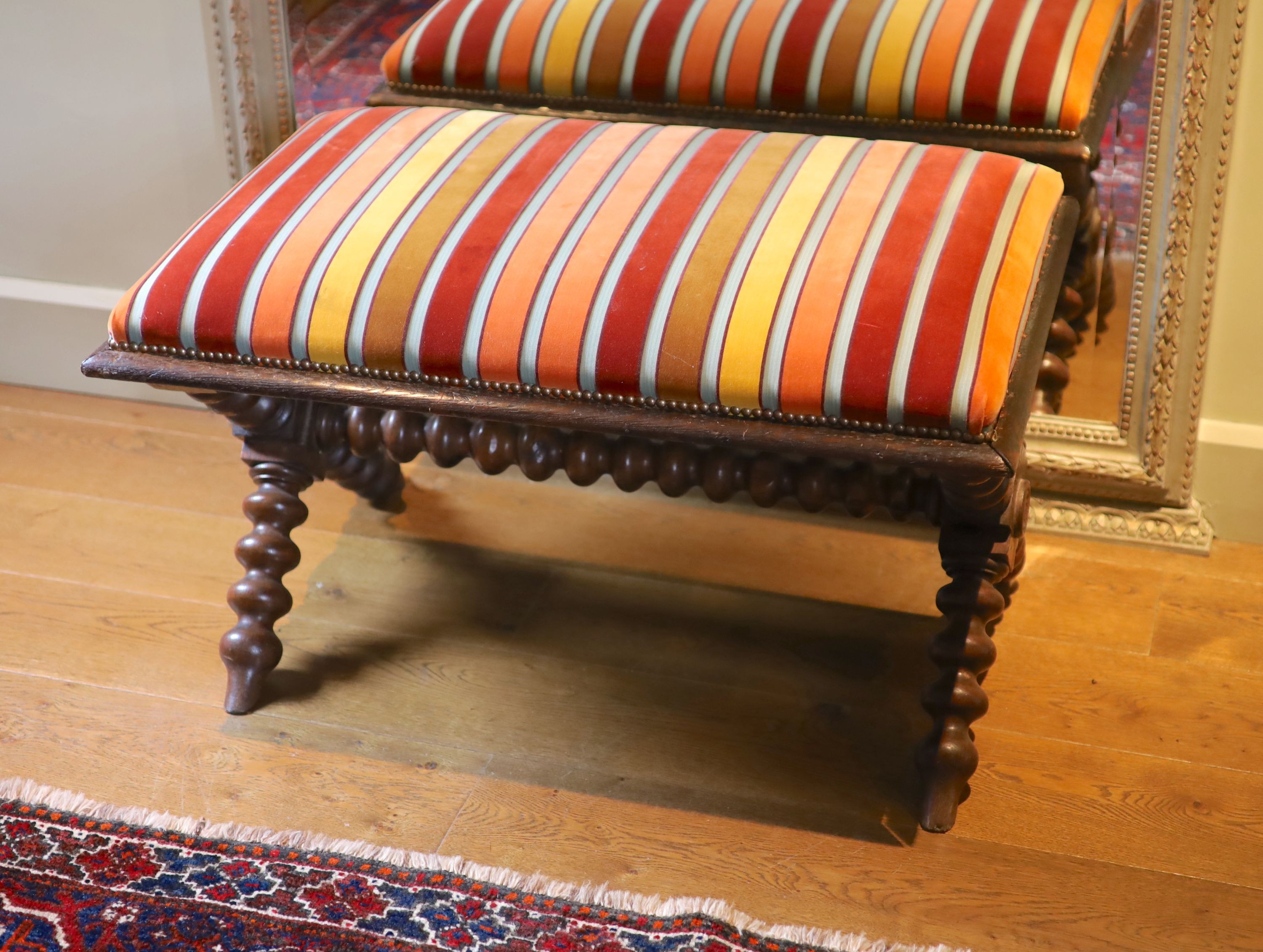 A Victorian stained oak stool, with striped upholstery and turned underframe, 90 x 60cm height 53cm